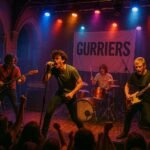 "Alternative rock band, Gurriers, performing on stage with energetic enthusiasm at an intimate music venue, St James in Guernsey. The audience is immersed in the music, cheering in the vibrant glow of colorful stage lights. The setting is adorned with band banners and musical equipment, creating an electric mood of a live indie or punk rock show."